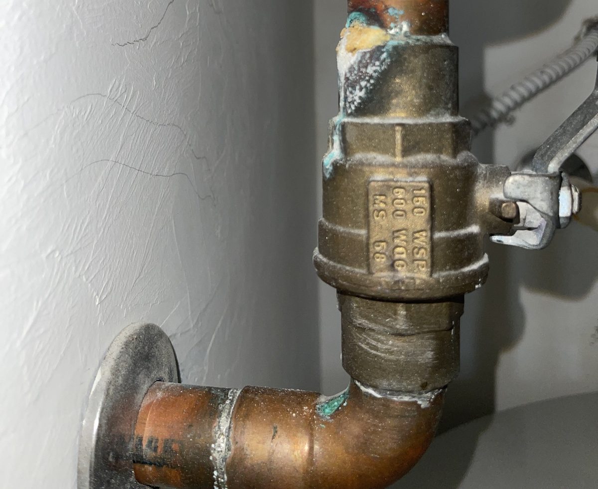 Heavy verdigris and mineral deposits on main valve